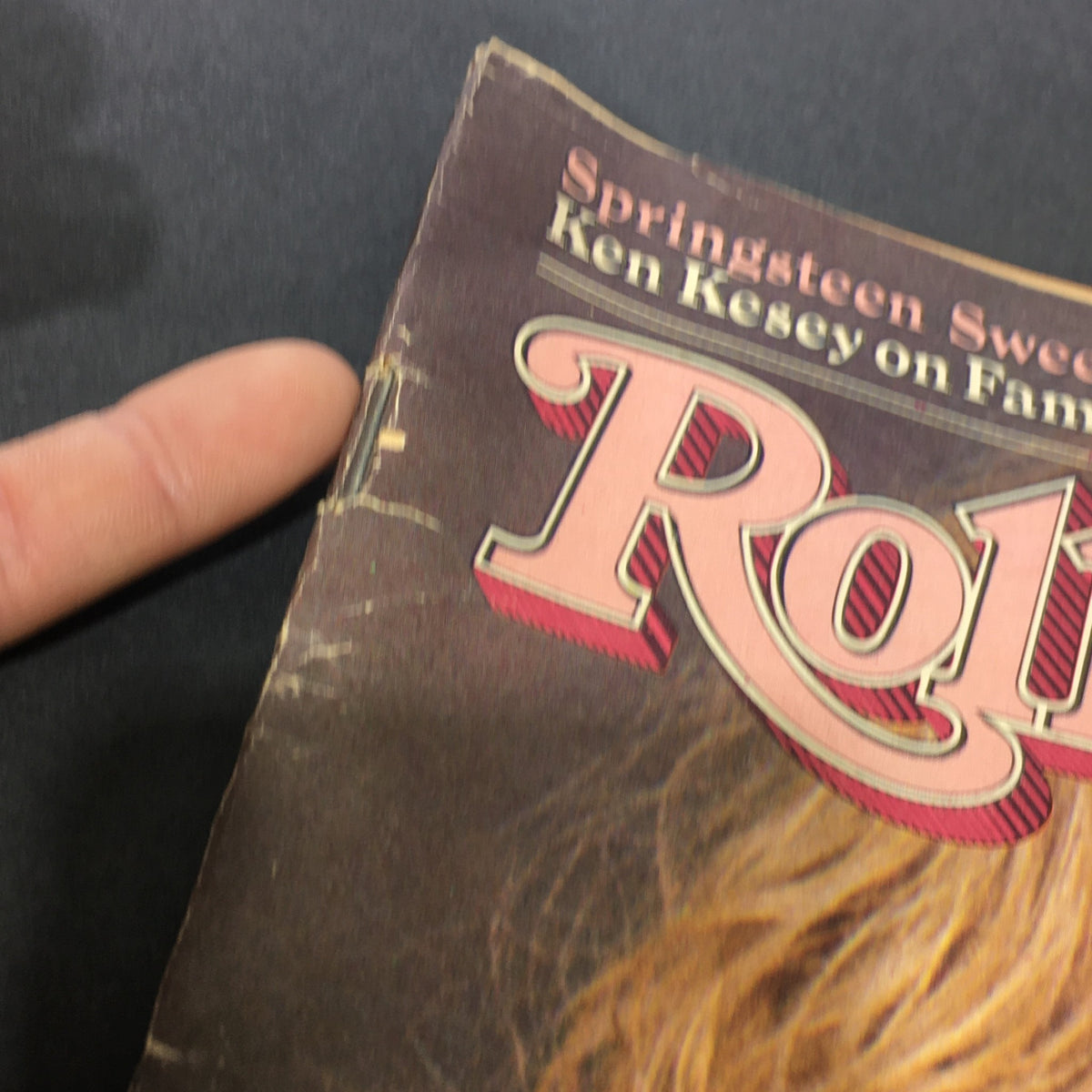 Close-up view of the top corner of the VTG Rolling Stone Magazine March 5 1981, highlighting some wear and the recognizable logo.