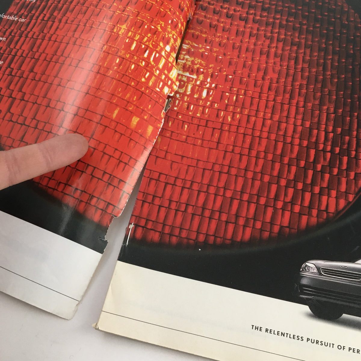 Interior view of The New Yorker Magazine January 31 2000 showing wear and tear, featuring a vibrant red advertisement page.