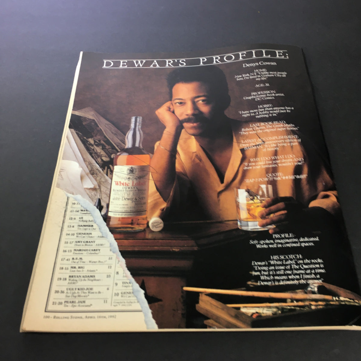 Inside page of the April 16, 1992 Rolling Stone Magazine showcasing an article by Denys Cowan, promoting Dewar's whiskey with a stylish photo.