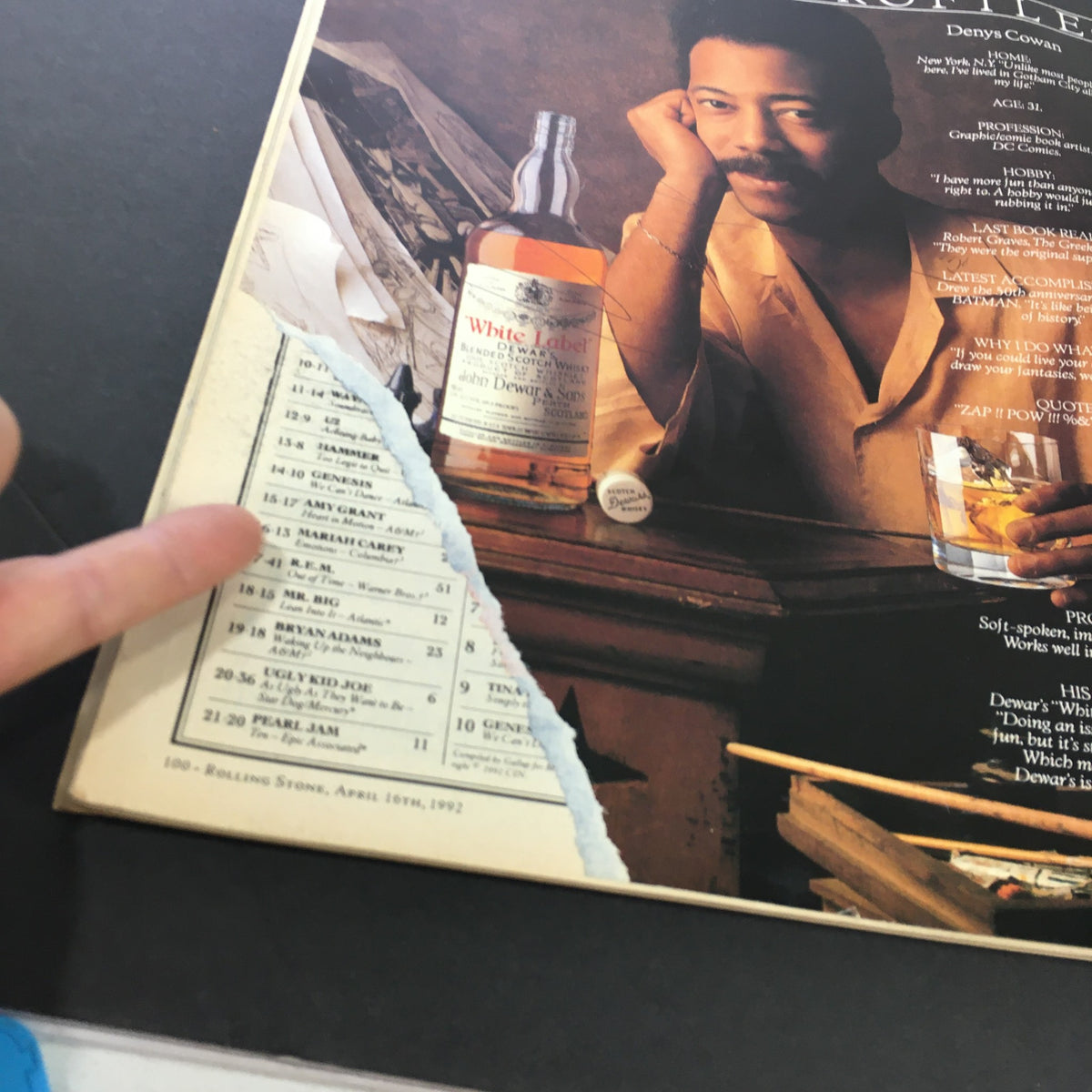 Detailed view of an advertisement featuring Denys Cowan in the April 16, 1992 issue of Rolling Stone Magazine, highlighting a music chart.