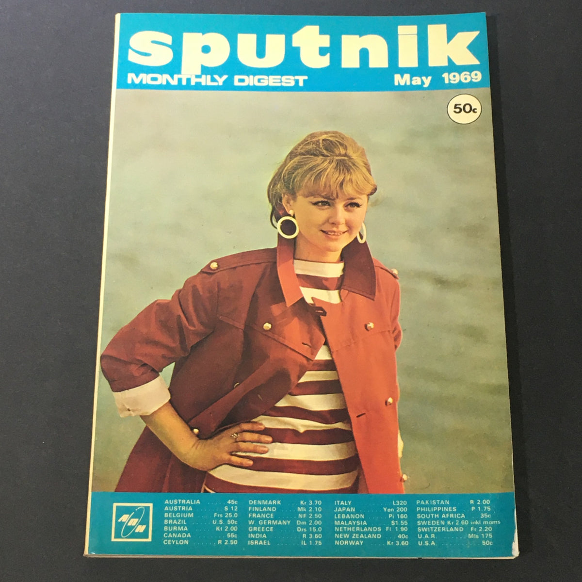 Cover of VTG Sputnik Monthly Digest May 1969, featuring a woman wearing a red jacket and earrings, highlighting the magazine's vibrant design and contributing to the 1960s aesthetic.