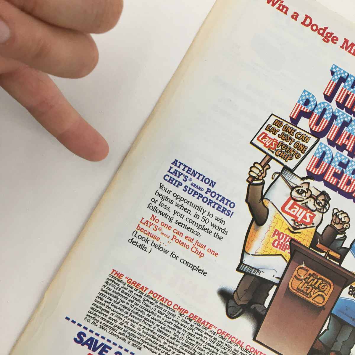 1984 Lay's Brand Potato Chips Debate Circular Coupon Advertisement featuring a character promoting Lay's potato chips, emphasizing the opportunity to win a Dodge vehicle, with a hand pointing to the advertisement details.