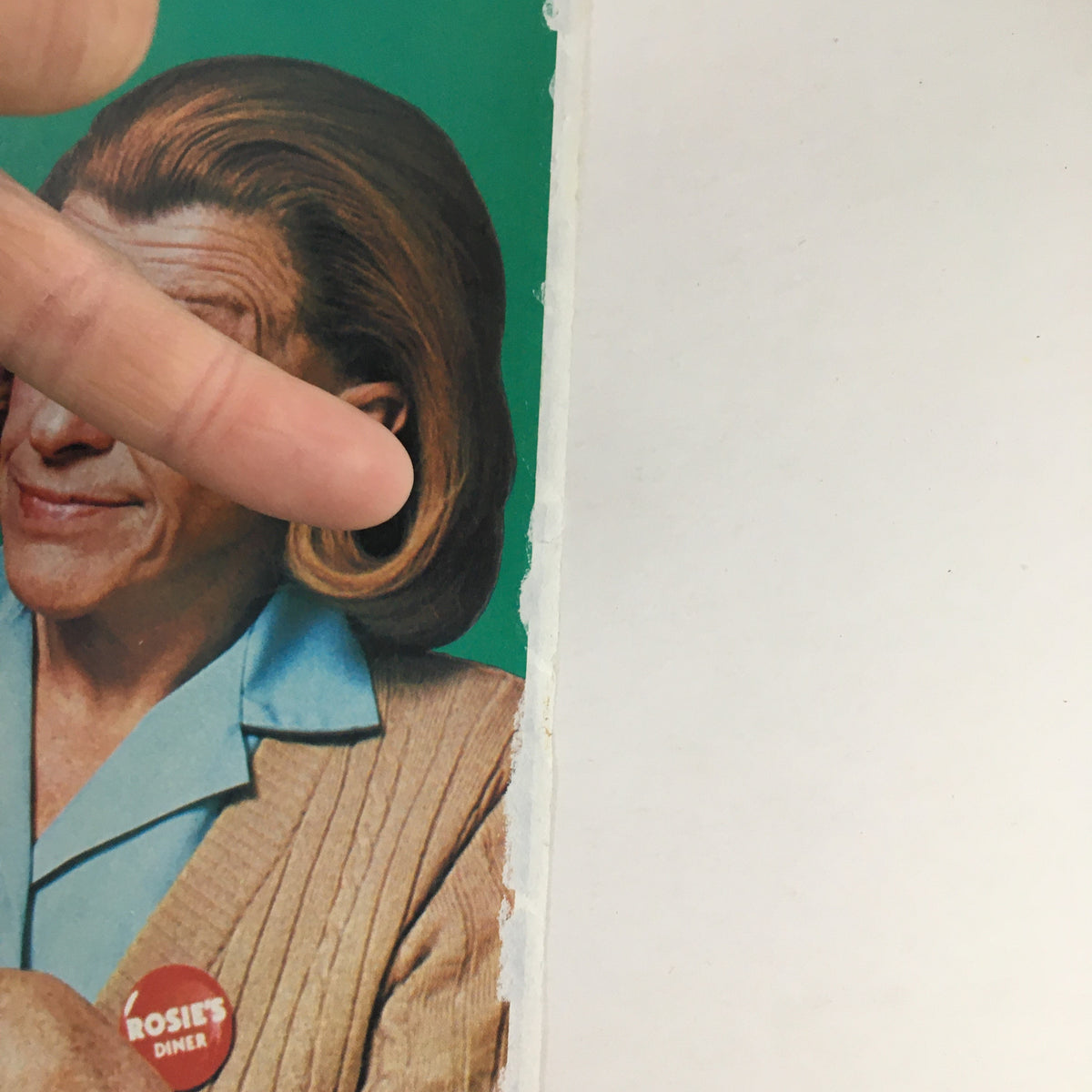 Partial view of the 1983 Bounty Coupon Advertisement featuring a woman's face with 'Rosie's Diner' button, promoting savings on Bounty paper towels.