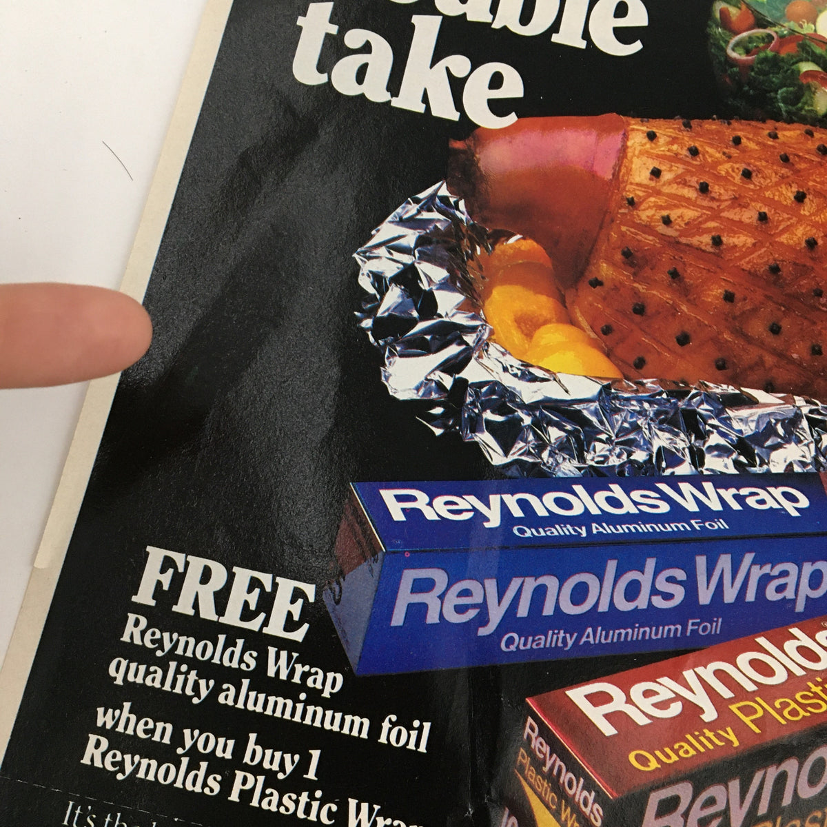 Close-up of the Reynolds Wrap advertisement showcasing the quality aluminum foil promotion alongside a cleverly presented food item in aluminum foil.