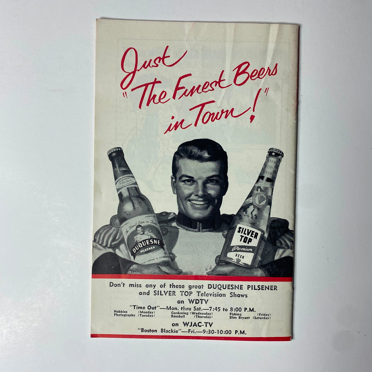 Advertisement page from TV Digest Magazine March 28, 1953 promoting 'Duquesne Pilsener' and 'Silver Top' beers. Features a smiling male model holding two bottles, showcasing local TV programming on WJAC-TV.