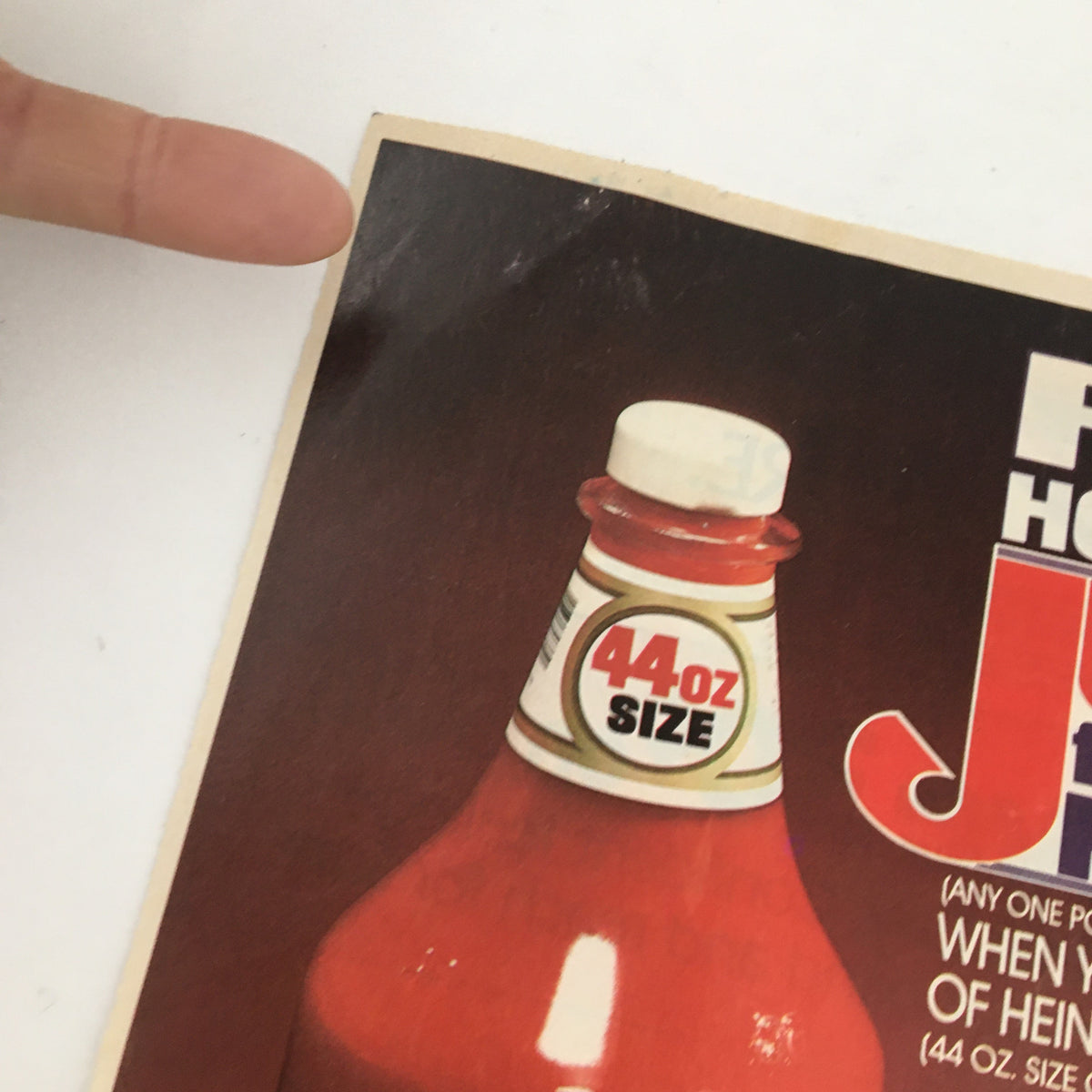 Close-up of 1985 Heinz Tomato Ketchup Circular Coupon Advertisement featuring a 44 oz. ketchup bottle with details about the product size and usage.