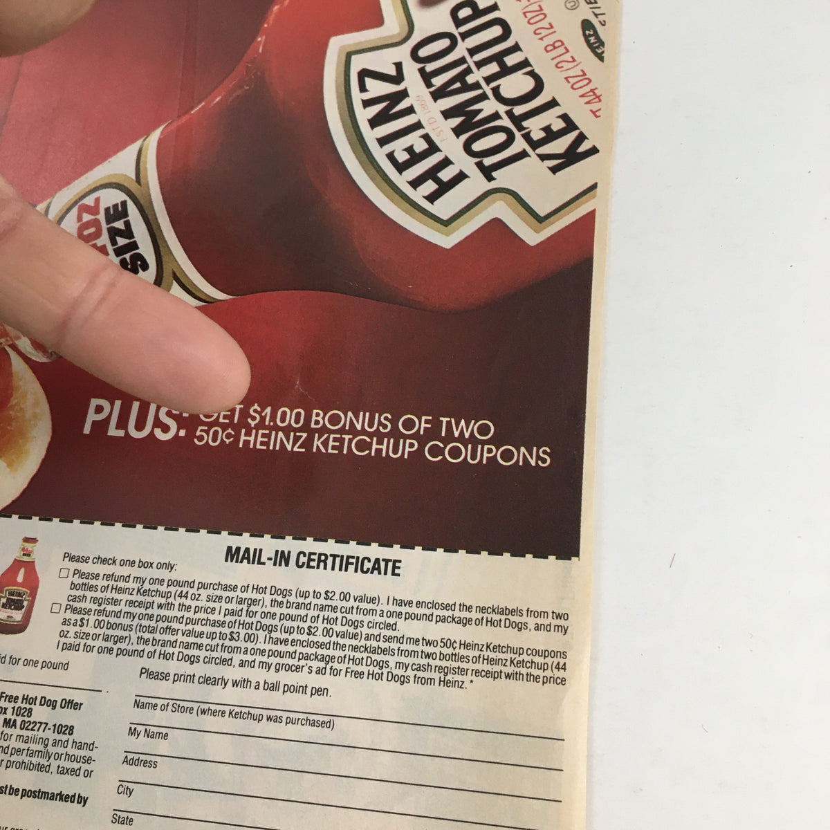 Bottom section of the 1985 Heinz Tomato Ketchup Circular Coupon Advertisement displaying a mail-in certificate for bonus Heinz ketchup coupons and hot dog purchase offer.