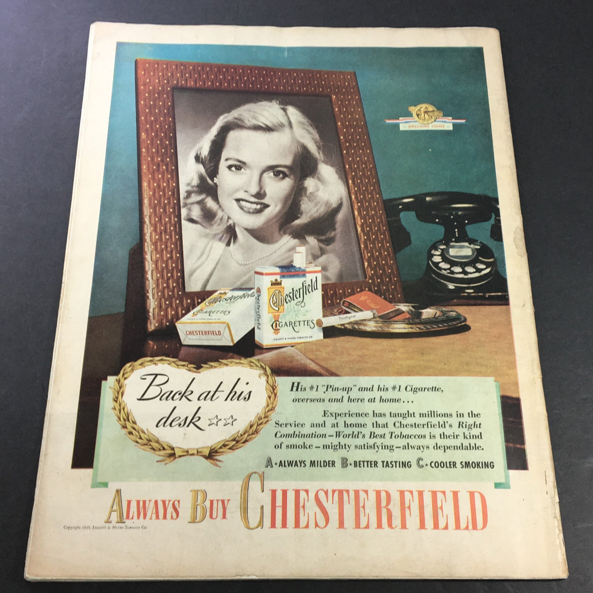 Vintage advertisement from Collier's Magazine featuring a woman with blonde hair in a decorative frame, promoting Chesterfield cigarettes, highlighting nostalgic elements such as a rotary phone and vintage styling. Part of the VTG Collier's Magazine November 17 1945 issue.