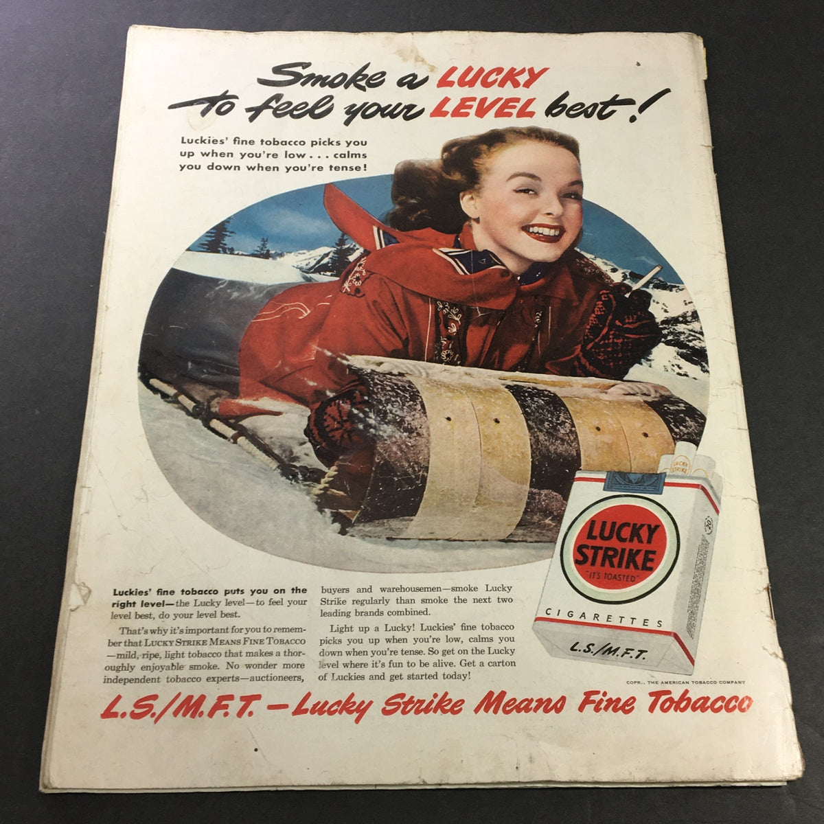 Vintage advertisement from Collier's Magazine February 12, 1949, featuring a smiling woman in winter attire promoting Lucky Strike cigarettes, highlighting the brand's appeal with the tagline 'Smoke a LUCKY to feel your LEVEL best!'.