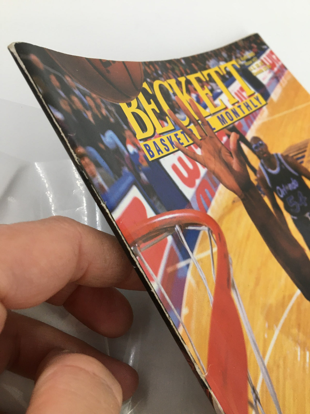 Side view of the Wesley Person Beckett Basketball #57 April 1995 magazine highlighting the wear on the cover, ideal for collectors.