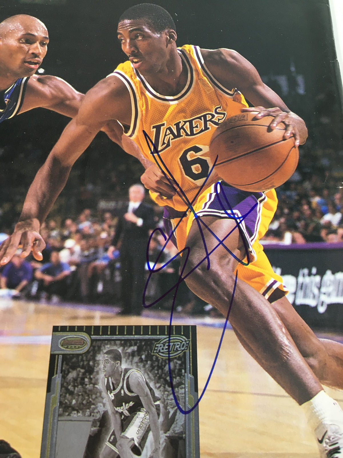 Close-up of Eddie Jones Beckett Basketball #84 July 1997 JSA Certified Autographed magazine with Eddie Jones dribbling in Lakers jersey and autographed basketball card.