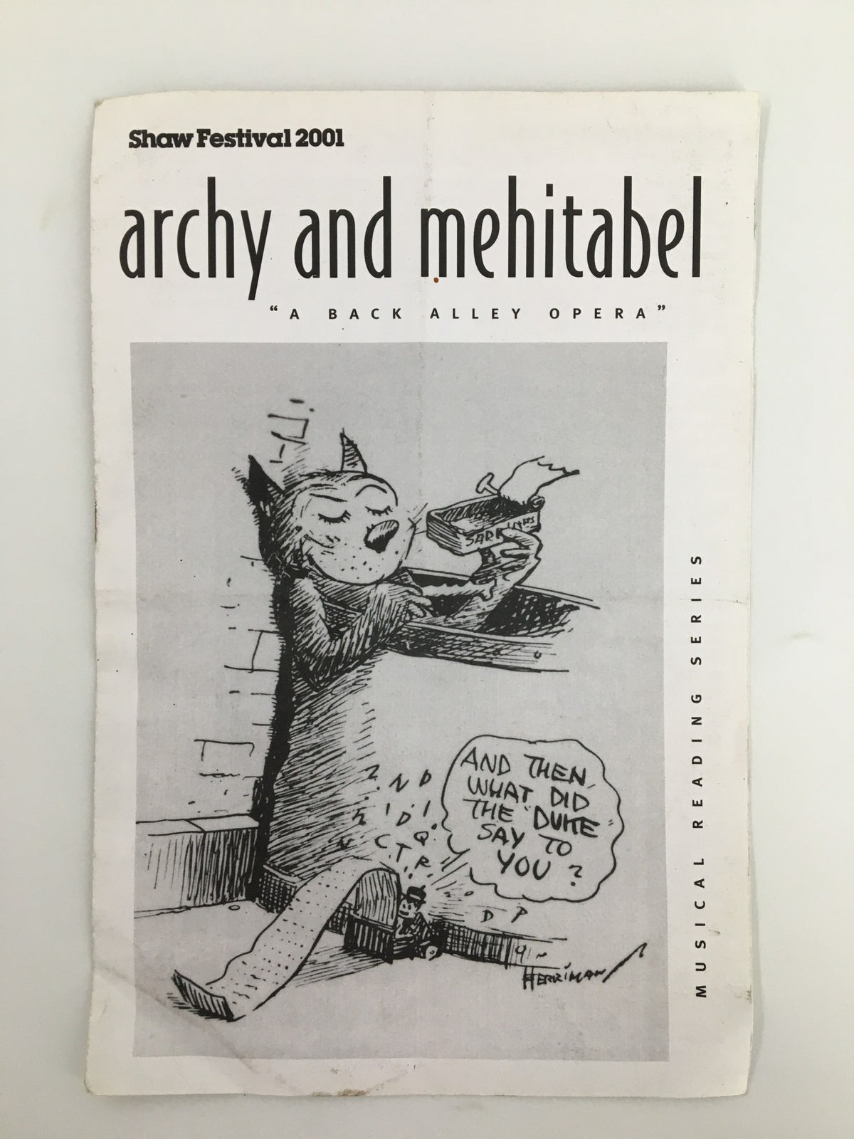 2001 Shaw Festival program for Archy and Mehitabel, featuring an illustration of a cat holding a book with a whimsical expression, highlighting its theatrical themes.