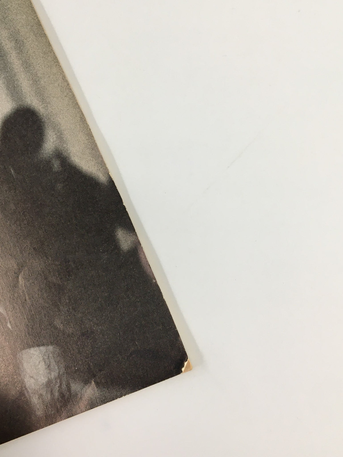 Close-up of the edge of the 1961 Playbill for 'An Evening with Yves Montand,' showing minor wear and vintage details.