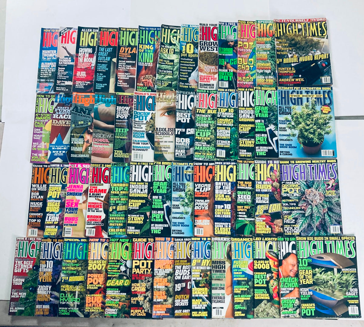Lot of 53 90s and Early 2000-2007 High Times Magazine issues displayed together, showcasing vibrant covers related to cannabis culture.