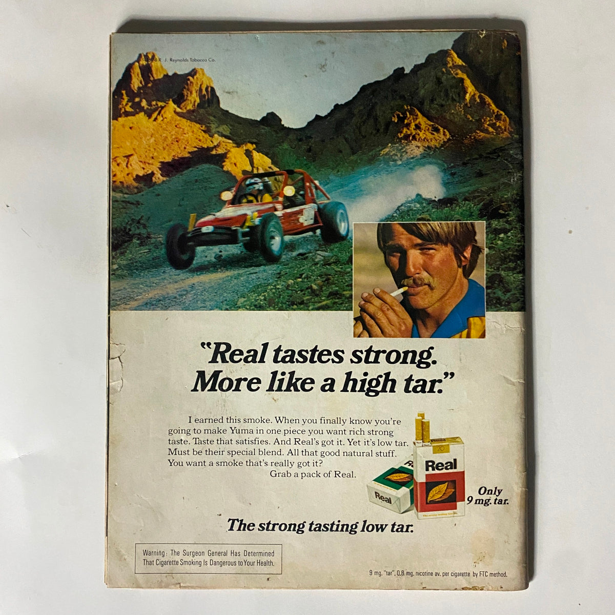 Back cover advertisement of the Sports Illustrated Magazine June 19, 1978, featuring a promotional image for Real cigarettes with a racing theme.