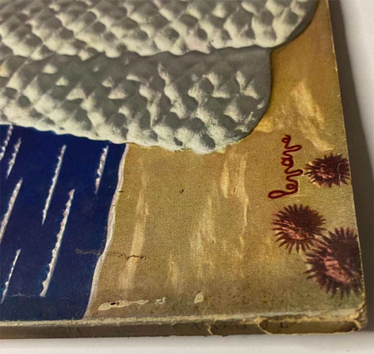 Detail of the cover art from Vogue Magazine July 1, 1938, titled 'Hot Weather Holidays' by Georges Lepape, featuring a woman in a textured dress and natural elements near the shore.
