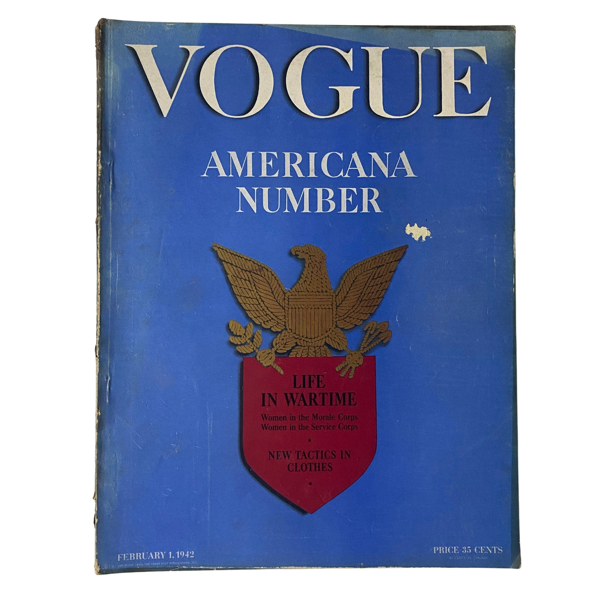 Cover of Vogue Magazine February 1, 1942 featuring the headline 'Life in Wartime' and emblematic eagle design, showcasing women's contributions in the Morale Corps and wartime fashion.