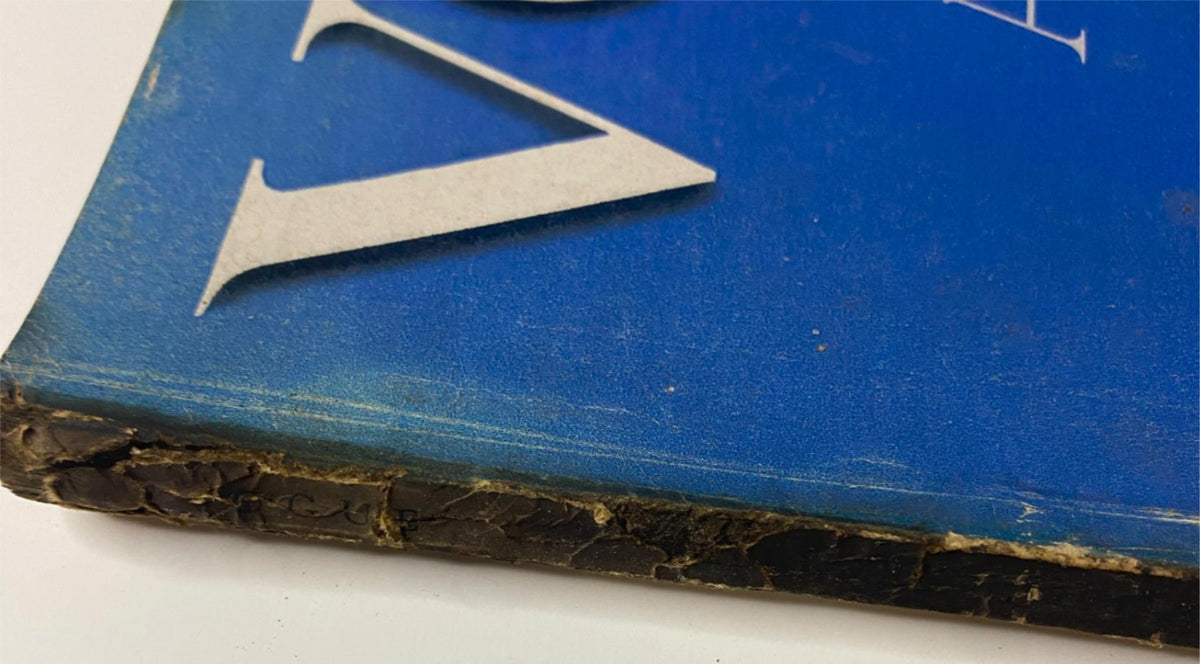 Close-up of the spine of Vogue Magazine February 1, 1942, displaying wear typical of vintage publications, associated with its coverage of 'Life in Wartime' and women's roles during World War II.