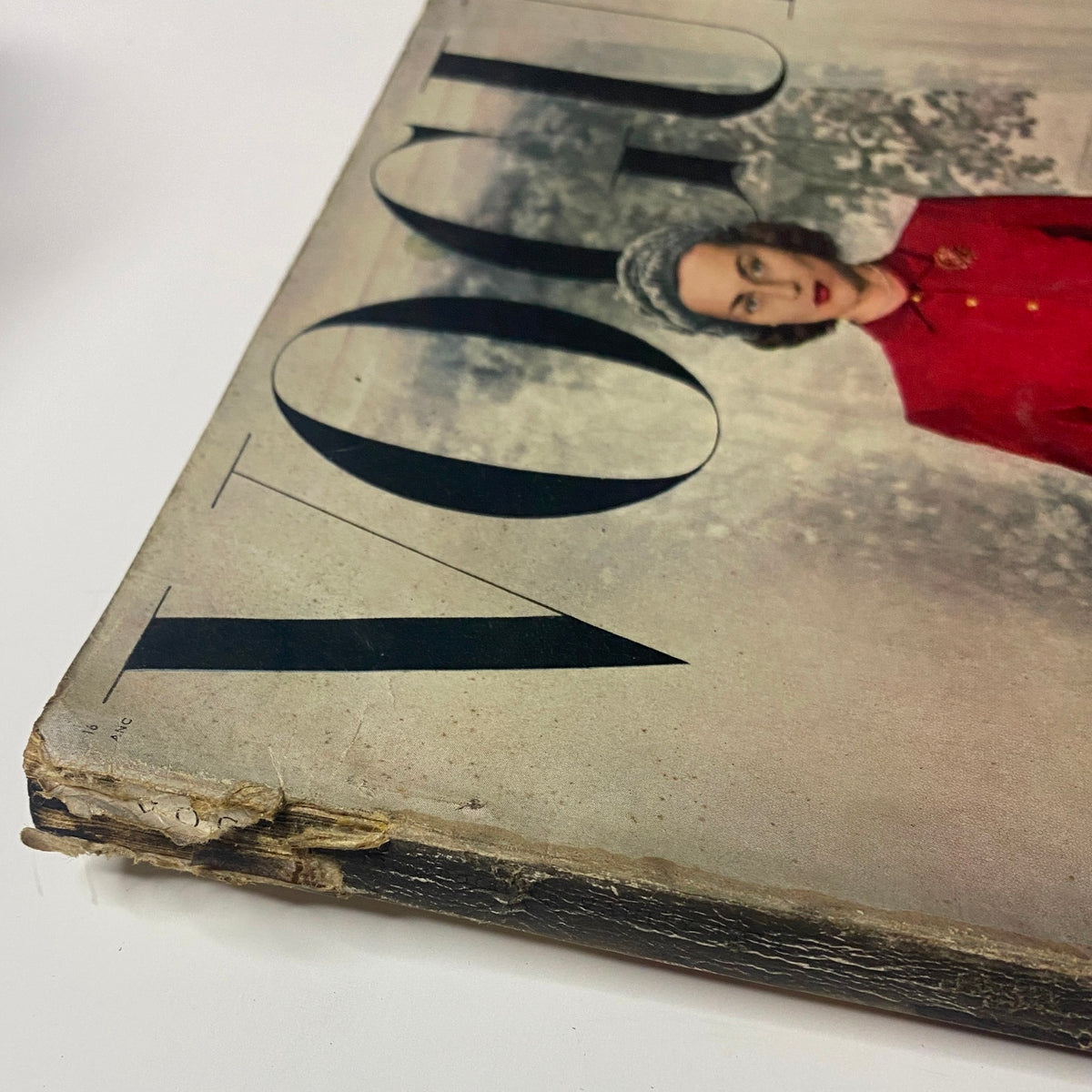 Corner of Vogue Magazine August 15, 1947 featuring model Joan Petit by Frances McLaughlin-Gill, showing wear on the spine of the magazine.
