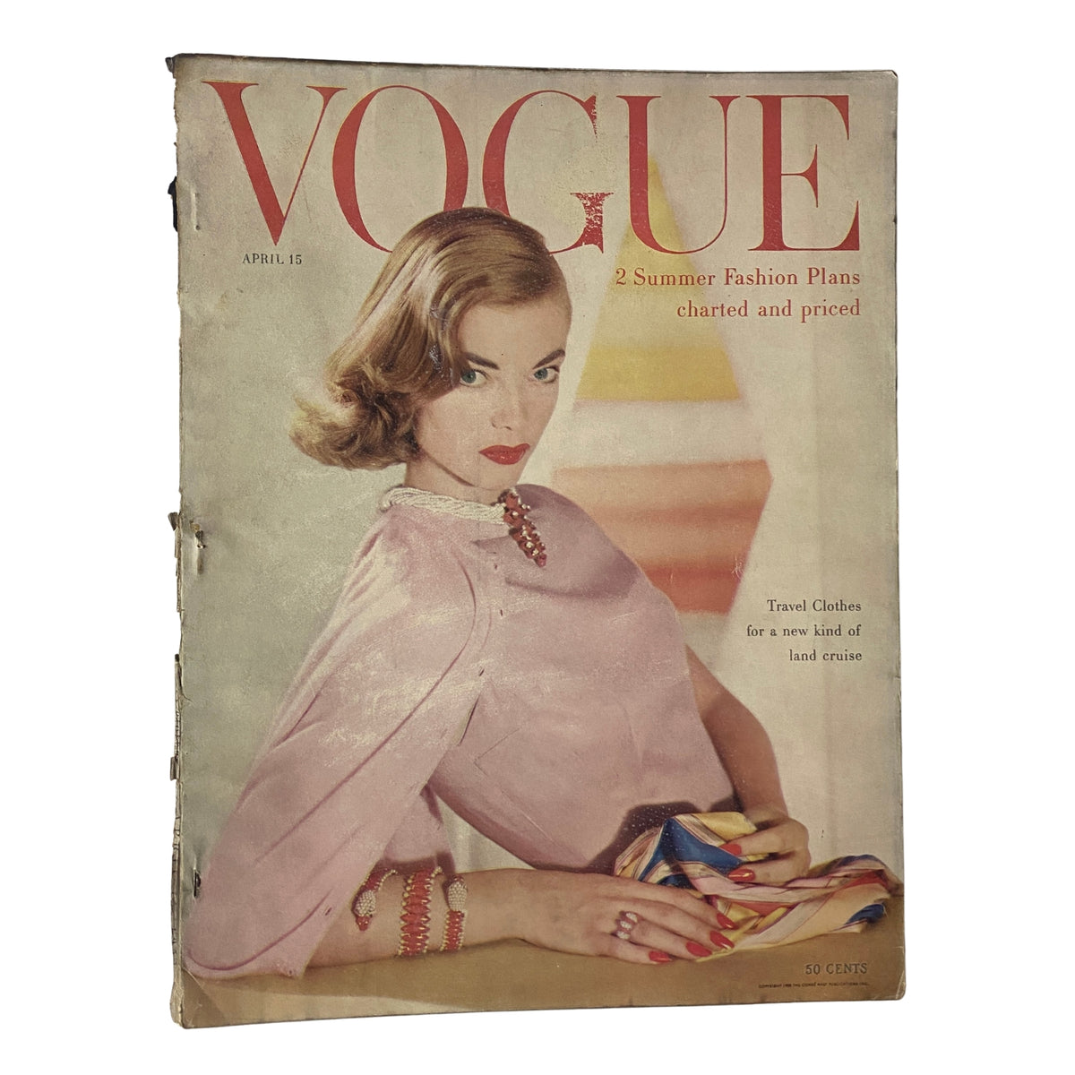Vogue Magazine April 15, 1955, featuring model Charlotte Payne on the cover styled in pink attire, showcasing mid-century fashion elegance with colorful background.