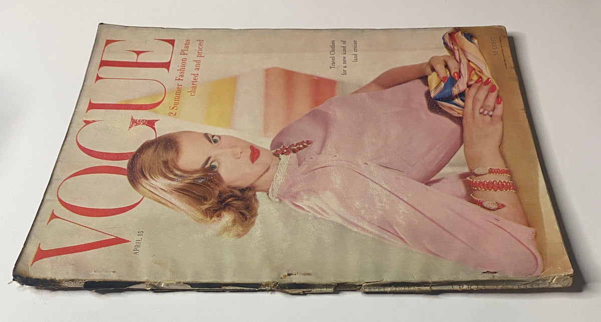 Side view of Vogue Magazine April 15, 1955, with cover image of model Charlotte Payne dressed in a pink blouse, emphasizing vintage magazine charm.