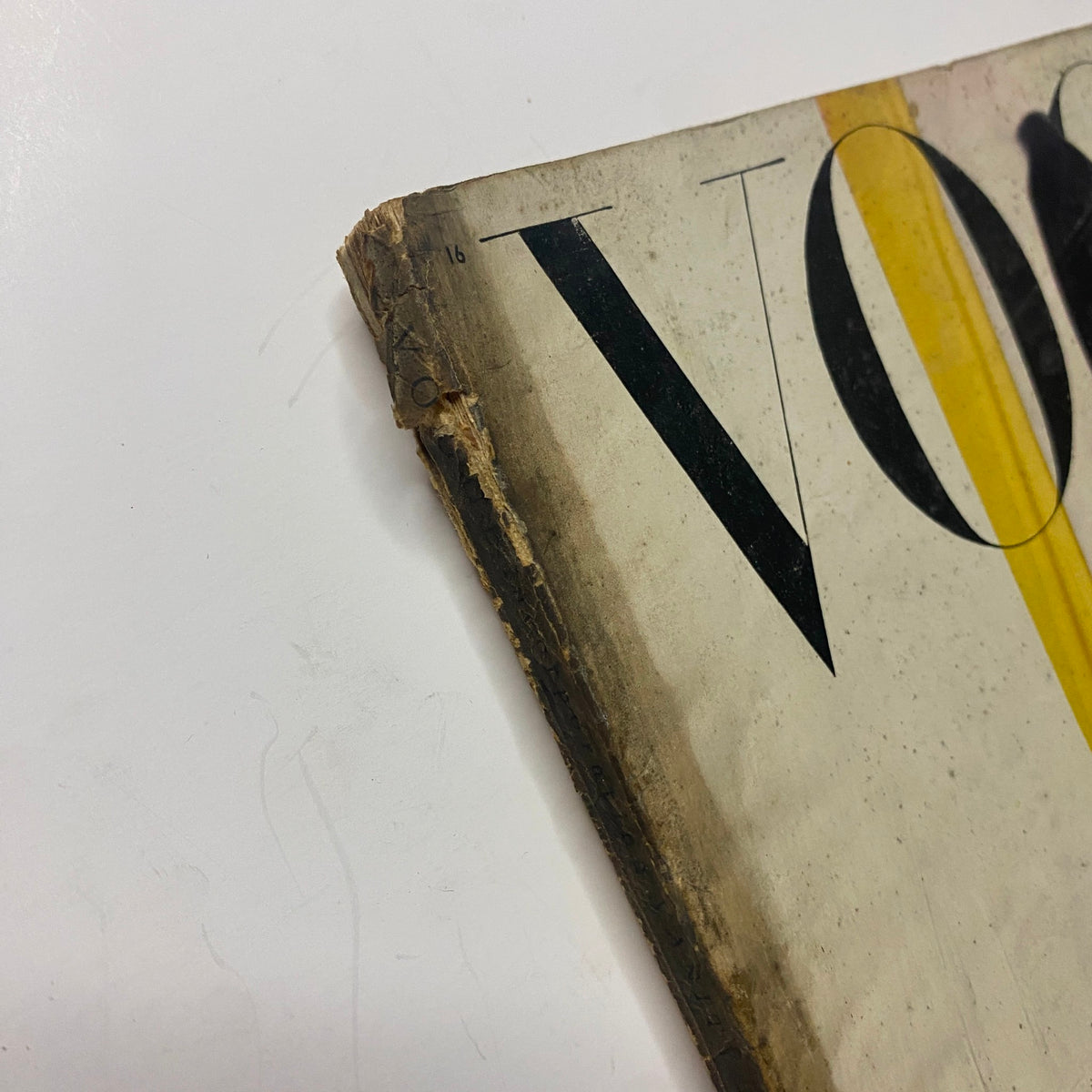 Close-up of the spine of Vogue Magazine August 15, 1945, highlighting vintage wear with minor damage, characteristic of a well-preserved archival item.