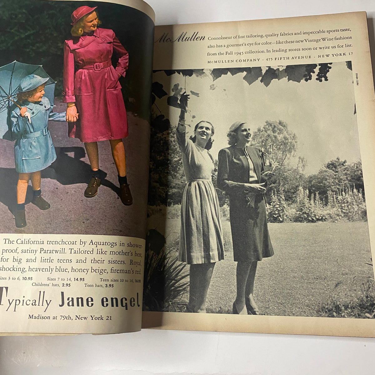 Inside Vogue Magazine August 15, 1945 featuring a fashion advertisement for children's clothing. Displays a mother and daughter in stylish raincoats, showcasing post-war fashion trends.