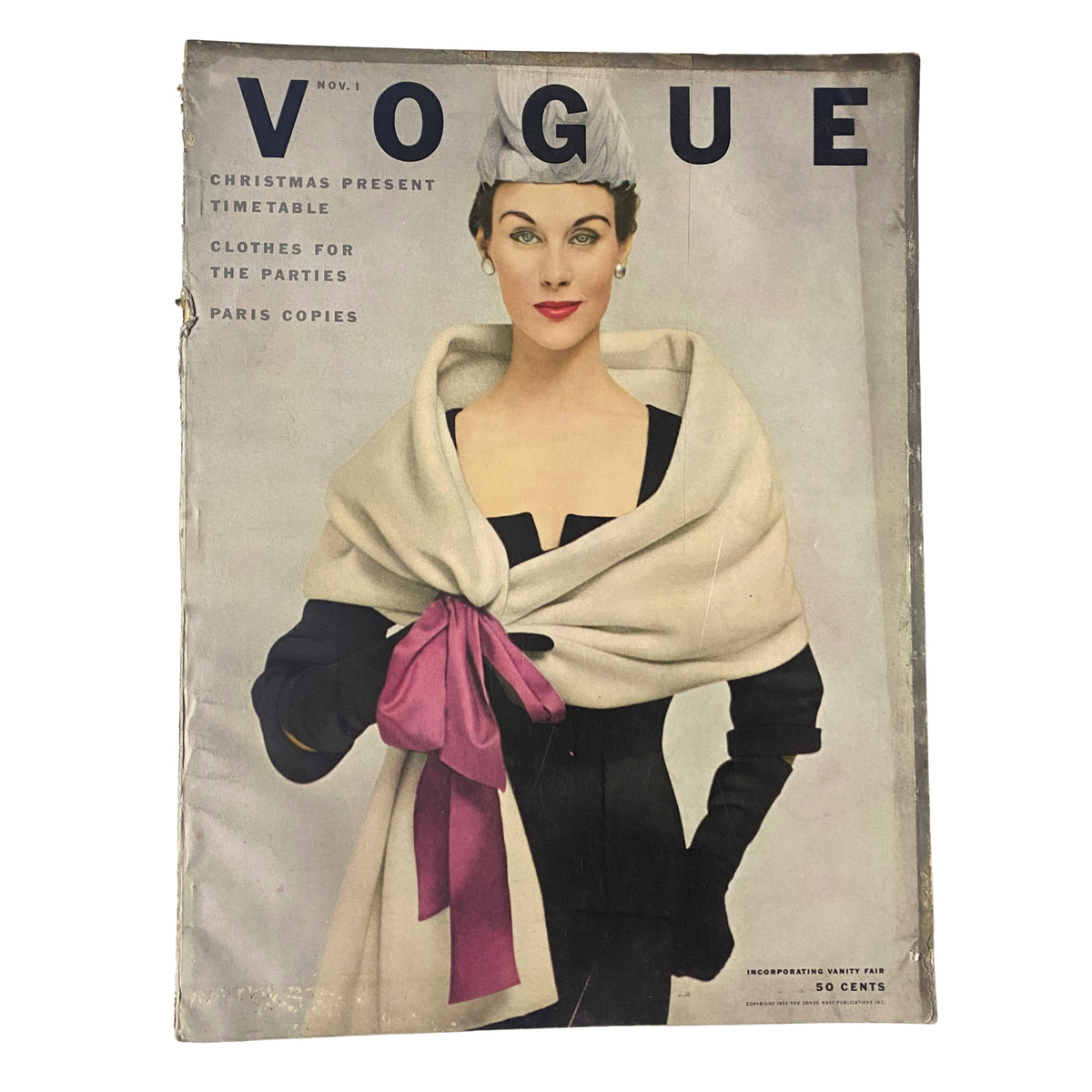 Vogue Magazine November 1, 1952 featuring Myrtle Crawford on the cover, showcasing a stylish model in a classic black dress with a white scarf and pink sash, representing mid-century fashion.