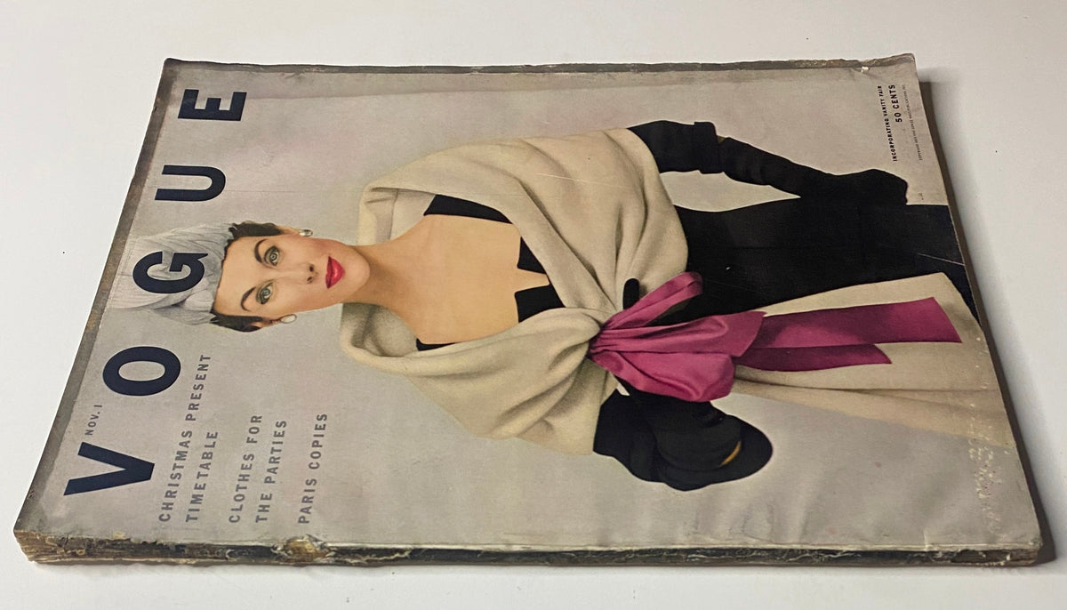 Cover of Vogue Magazine from November 1, 1952, presenting model Myrtle Crawford in elegant attire, featuring a black dress adorned with a cream-colored shawl and pink accent, an iconic example of 1950s fashion.