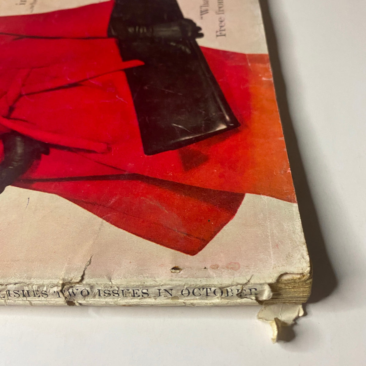 Close-up view of the damaged outer spine of Vogue Magazine October 1, 1960 Dorothy McGowan Cover by Irving Penn, showing wear and vintage traits typical of the era.