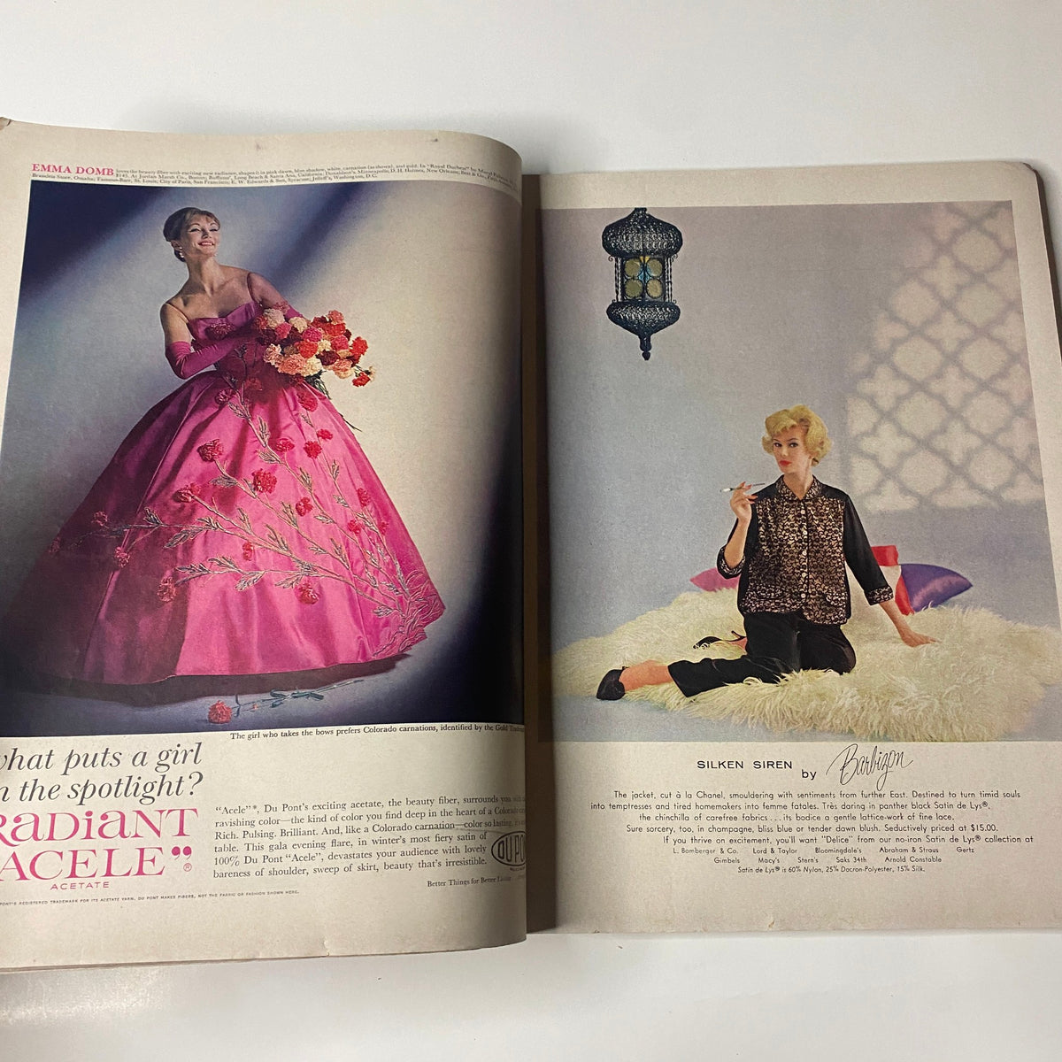 Two-page spread from Vogue Magazine October 1, 1960, featuring a model in a pink gown and another in stylish attire, highlighting mid-century fashion trends.
