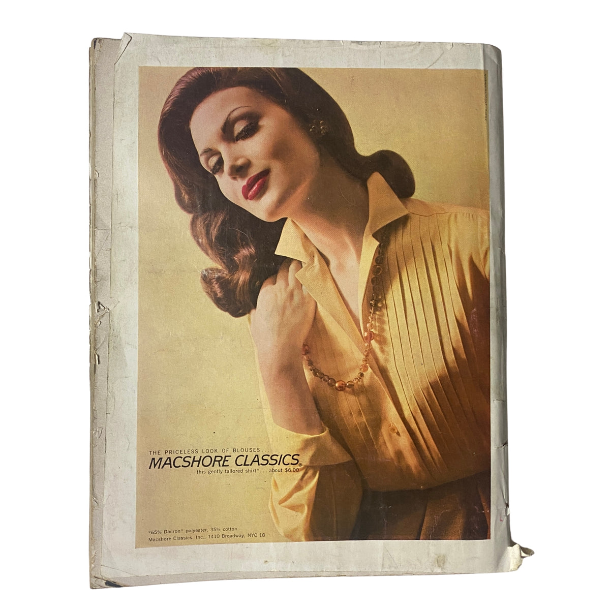 Back cover of the October 1, 1960 Vogue Magazine featuring a glamorous model promoting Macshore Classics jewelry, showcasing the elegance and aesthetic of early 1960s fashion.