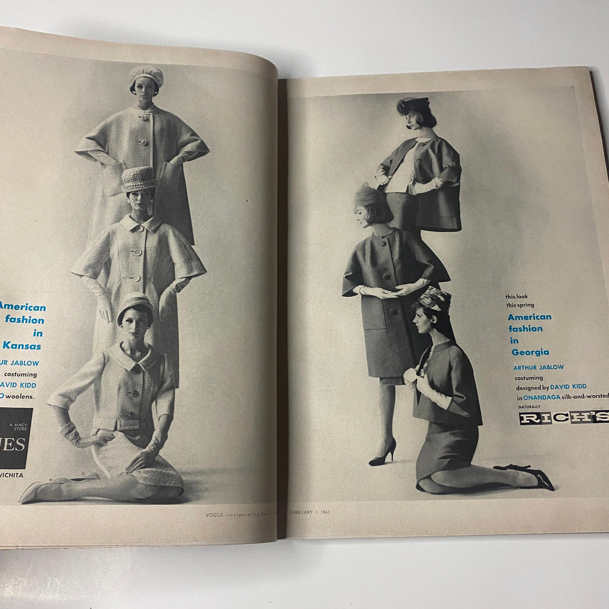 Interior fashion spread from Vogue Magazine February 1, 1961, featuring models in stylish coats, emphasizing the fashion trends of the early 1960s.