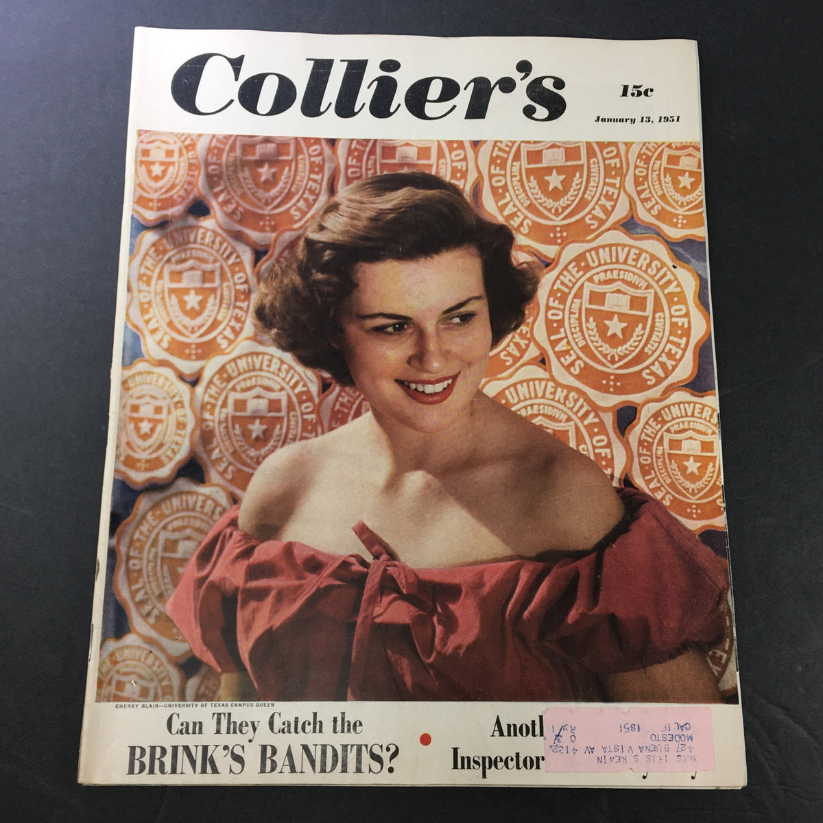 Cover of VTG Collier's Magazine dated January 13, 1951 featuring the title 'Can They Catch the Brink's Bandits?' with a smiling woman dressed in a red off-shoulder top and a background of university seals.