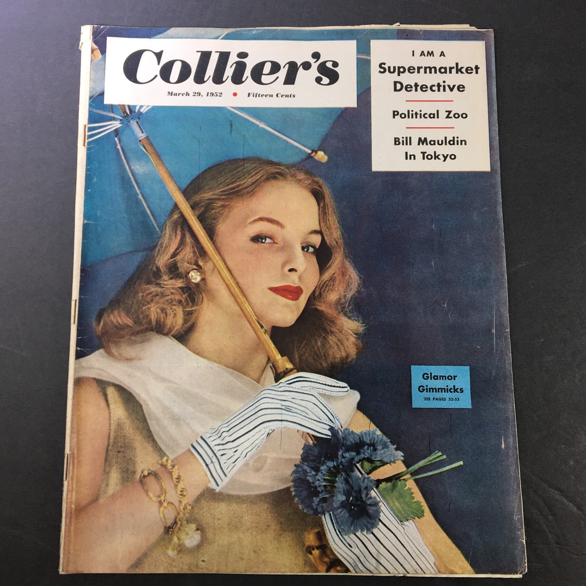 Vintage Collier's Magazine cover from March 29, 1952, featuring an elegant woman with a flower bouquet and umbrella, highlighting the article 'Stopover in Tokyo' by Bill Mauldin.