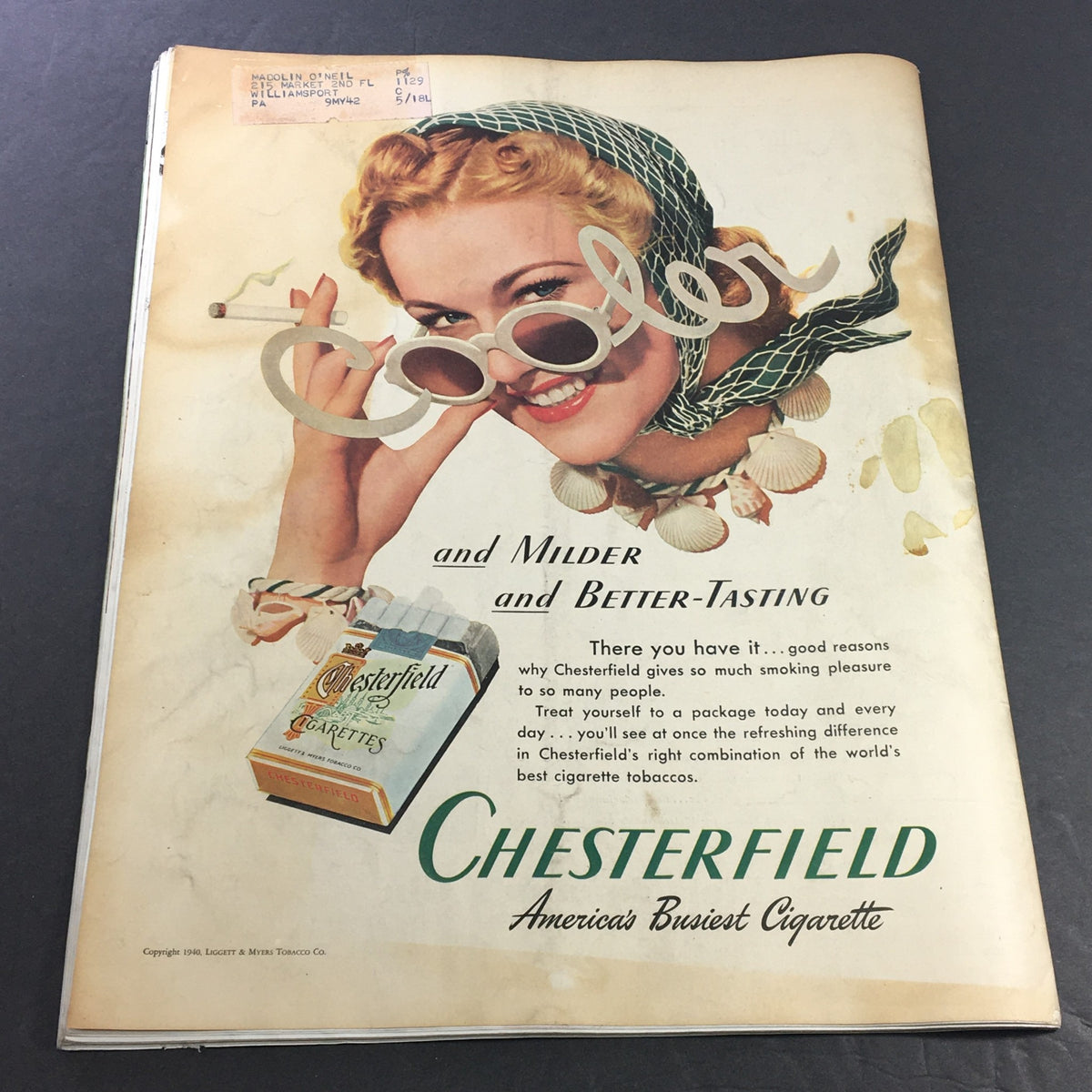 Cover image of the vintage Collier's Magazine, July 20, 1940, highlighting a woman with sunglasses promoting Chesterfield cigarettes. The advertisement emphasizes the cool and mild taste of Chesterfield, representing the cultural trends of the era.