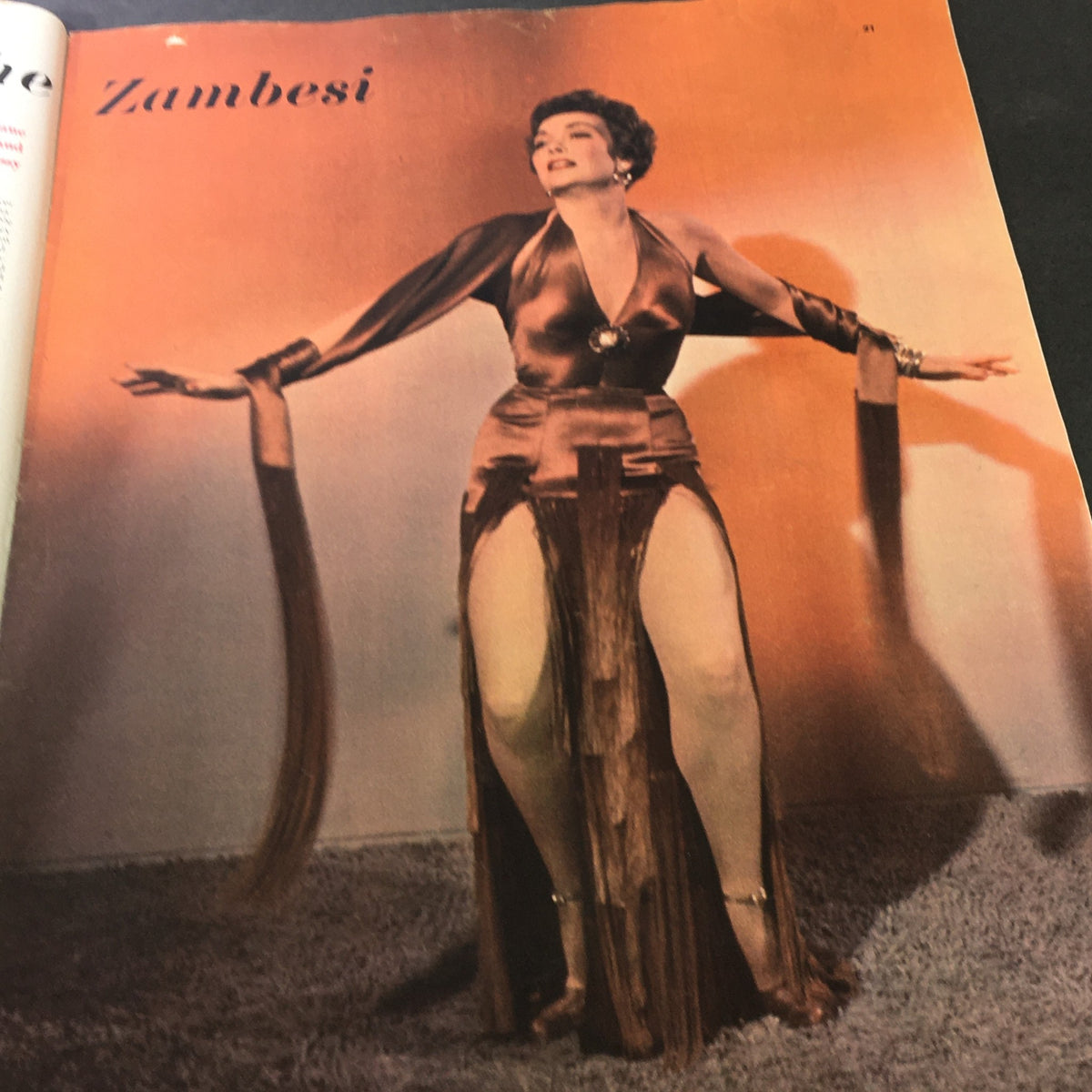 A glamorous actress performing in 'Zambesi' featured in Collier's Magazine January 10 1953, showcasing vintage fashion.