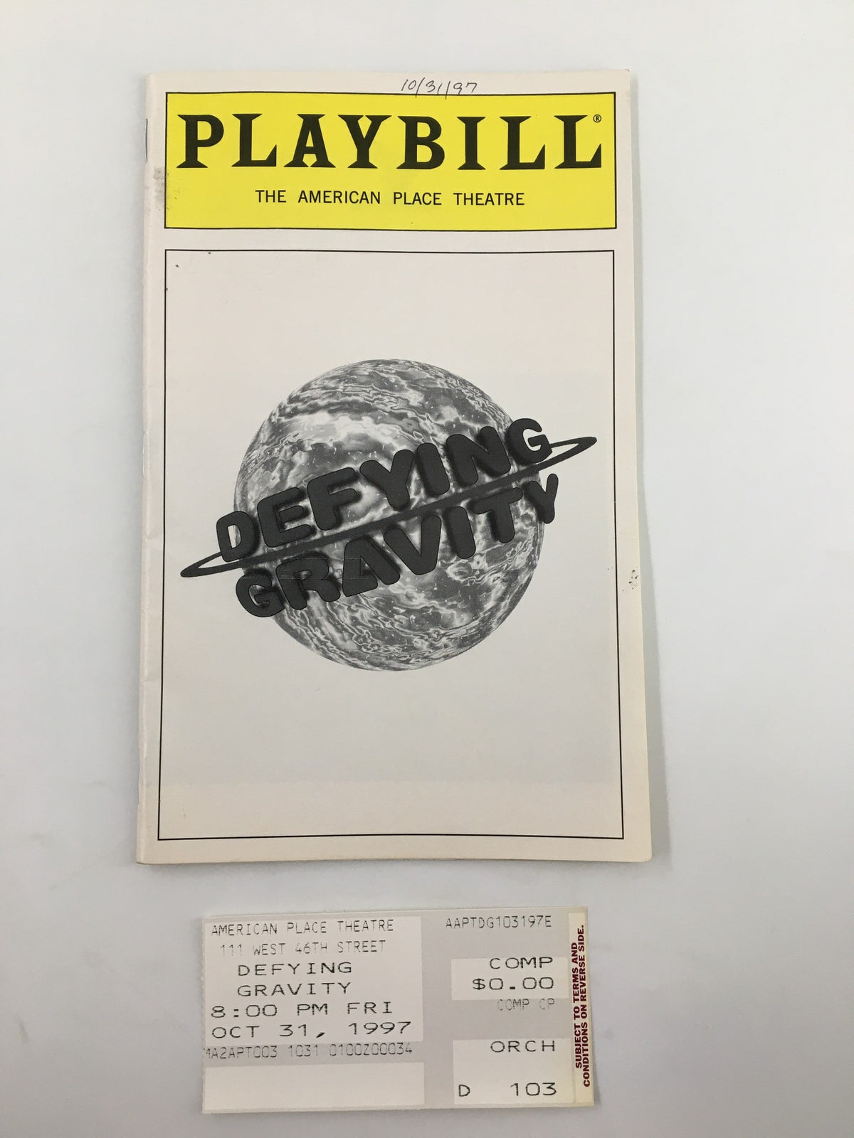 1997 Playbill from The American Place Theatre featuring Candy Buckley in Defying Gravity, showcasing an iconic black and white cover with a planet design.