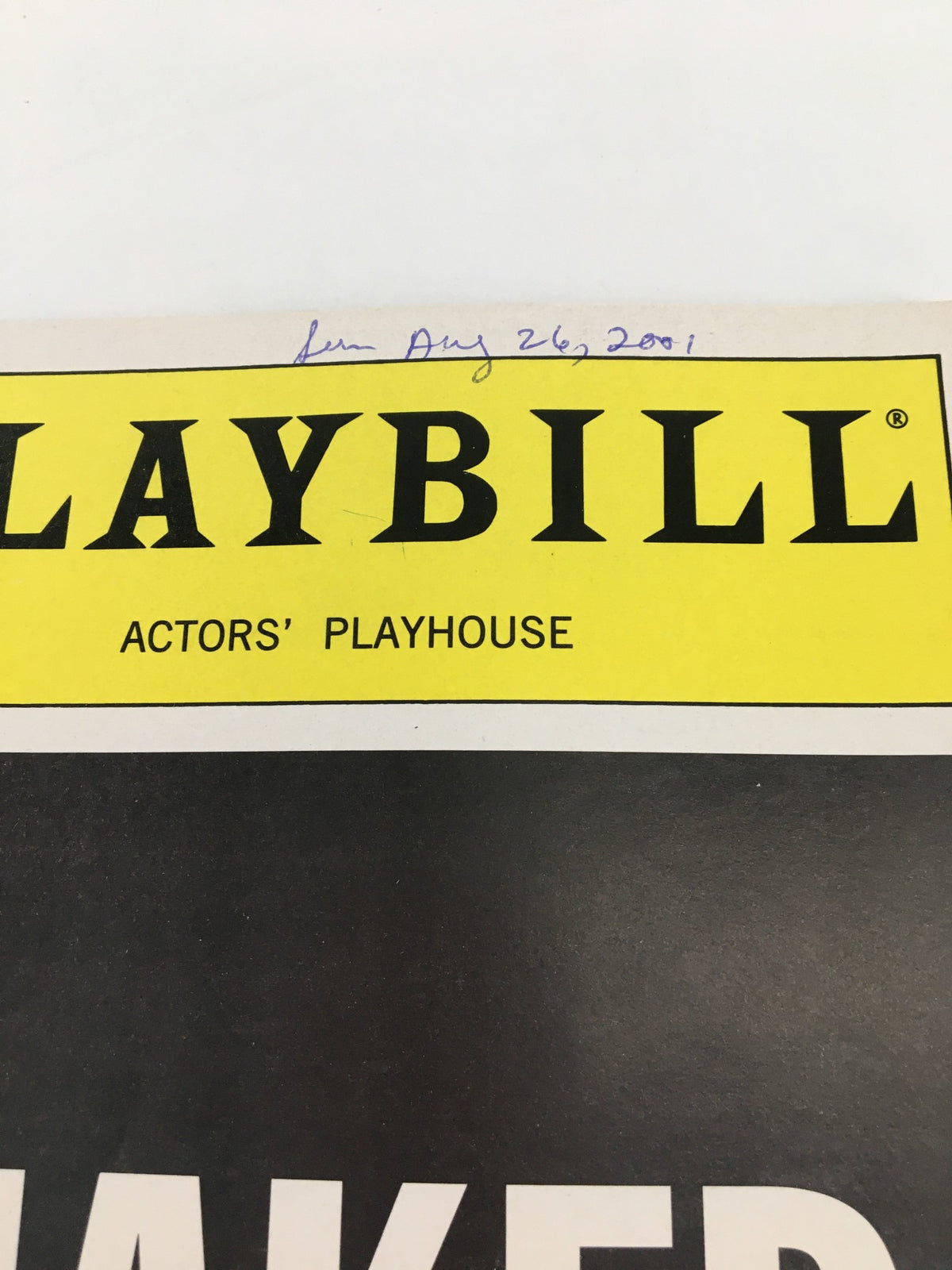 Close-up of the 2001 Playbill for Naked Boys Singing at The Actors' Playhouse, featuring the title and date written in ink, emphasizing its collectible nature.
