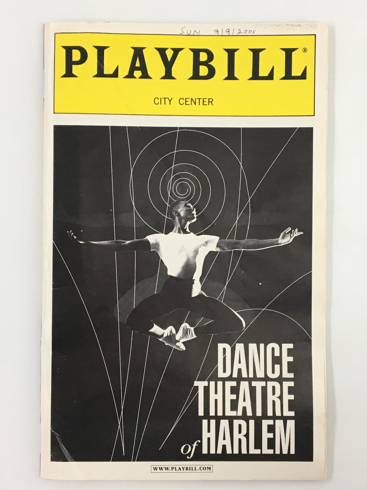 2000 Playbill for the Dance Theatre of Harlem, featuring a dancer in mid-leap against a geometric background, showcasing the artistic legacy of Arthur Mitchell.