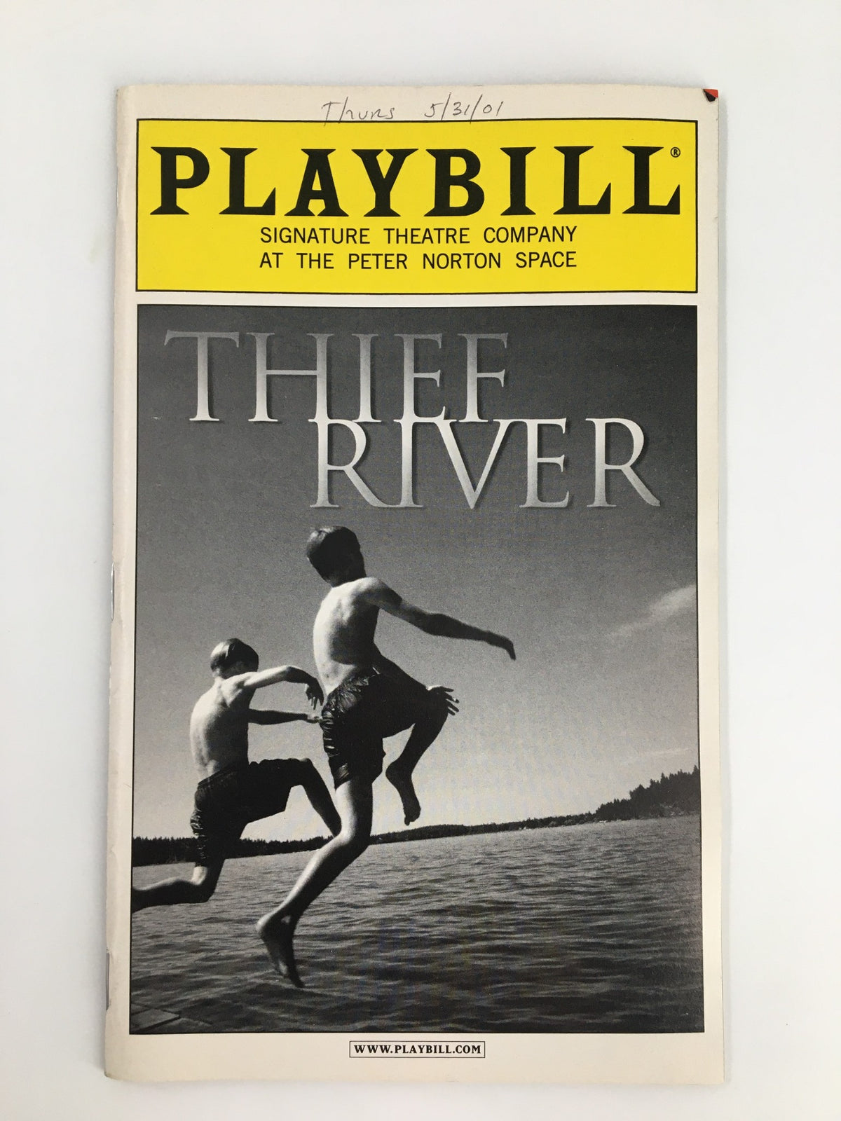 2001 Playbill for Thief River, produced by Signature Theatre Company, featuring a striking black and white cover image of two boys jumping into water, with promotional text and details about the show.