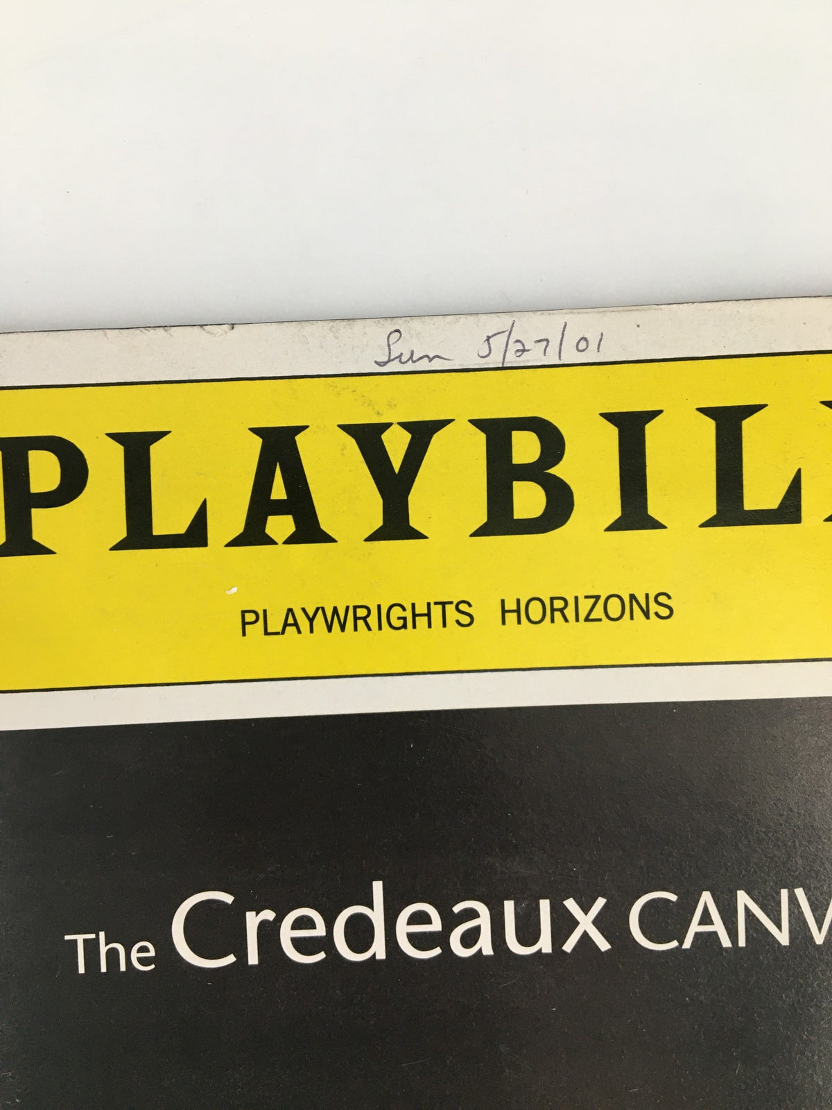 Close-up view of a 2001 Playbill header from Playwright Horizons featuring Glenn Howerton in The Credeaux Canvas, showing details such as the date written in pencil.