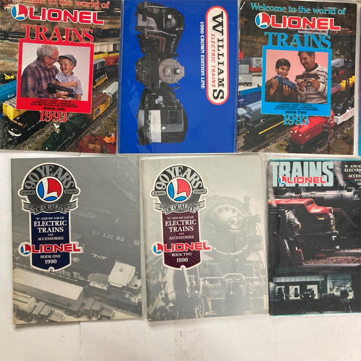 Lot of 23 1990s Lionel Electric Trains and Accessories Catalog displaying close-up images of Lionel train magazines from 1990.