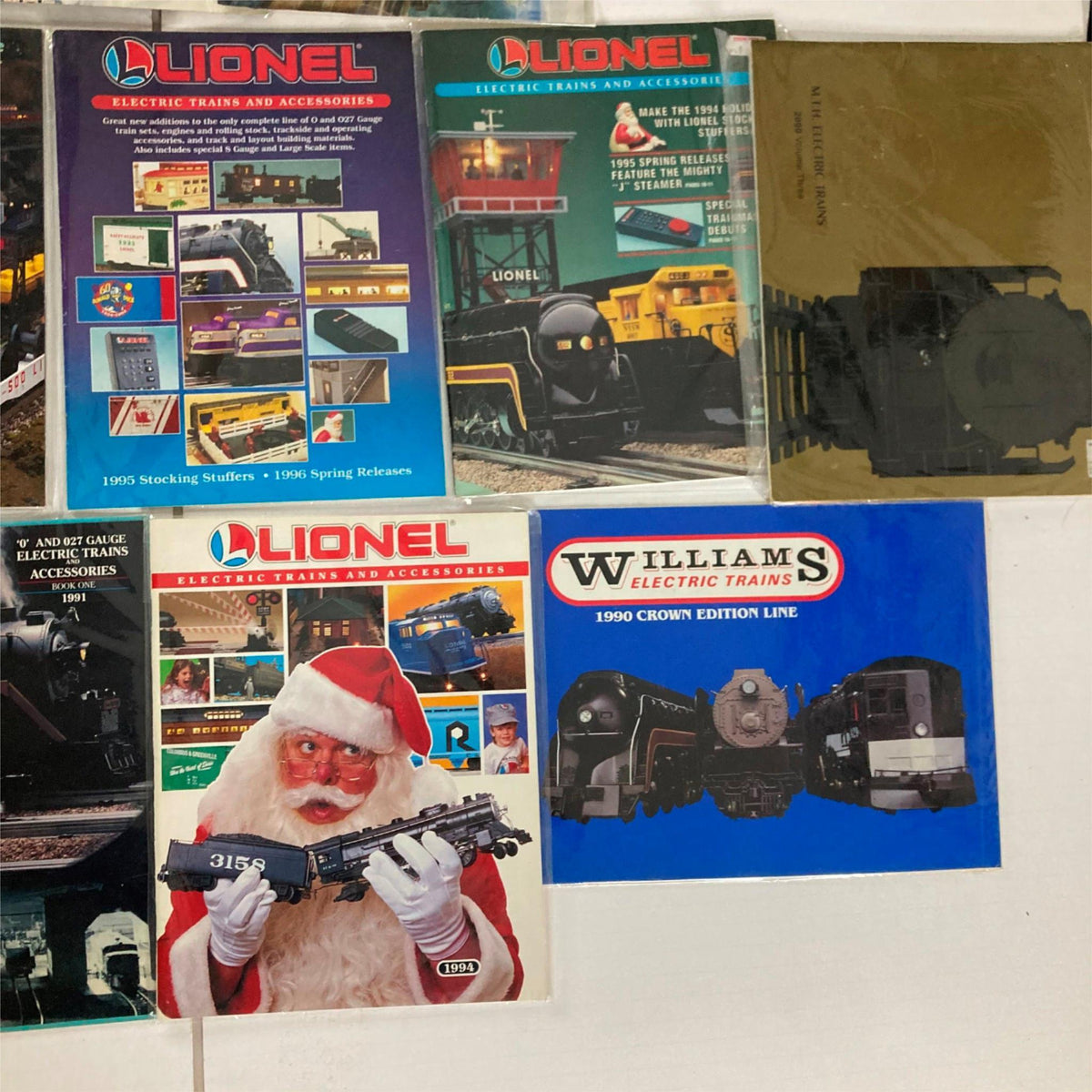 Lot of 23 1990s Lionel Electric Trains and Accessories Catalog showing a collection of Lionel train and accessories brochures including Williams Electric Trains.