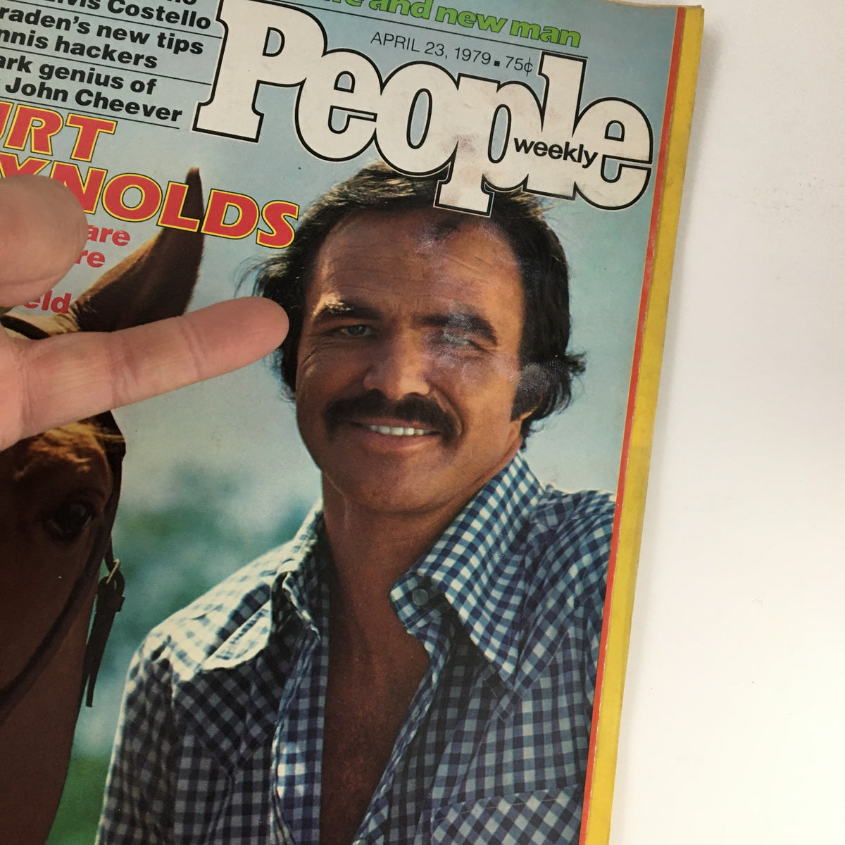 Detailed view of People Weekly Magazine cover from April 23, 1979, showcasing Burt Reynolds smiling, with visible wear, capturing a nostalgic moment from Hollywood's golden age.
