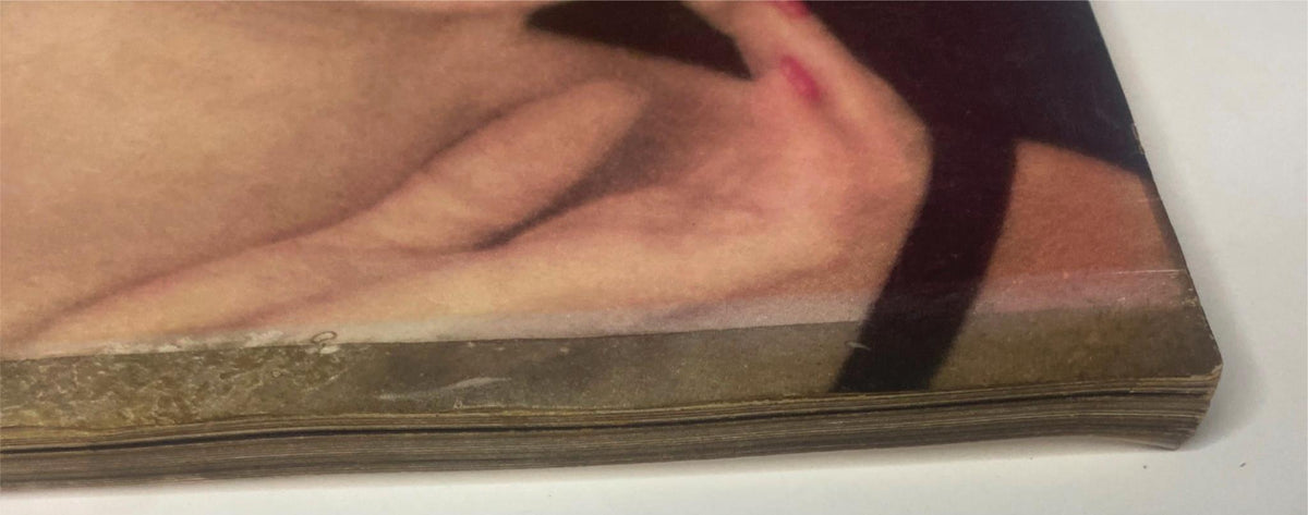 Close-up of the spine of Vogue Magazine November 15, 1955 featuring Anne St. Marie cover by Henry Clarke, showing vintage wear and edge toning.
