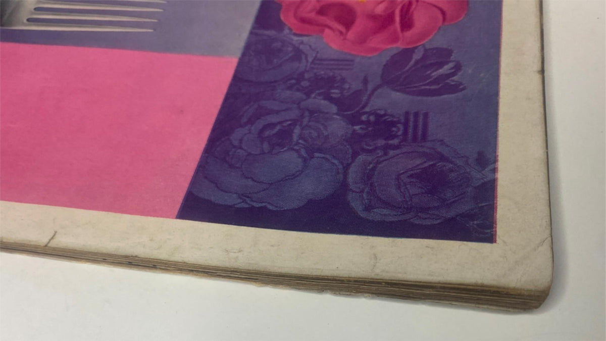 Detail view of the vintage pages from Vogue Magazine June 15, 1947 Joan Pedersen Cover by René Bouché, showing slight aging and design elements with floral motifs.