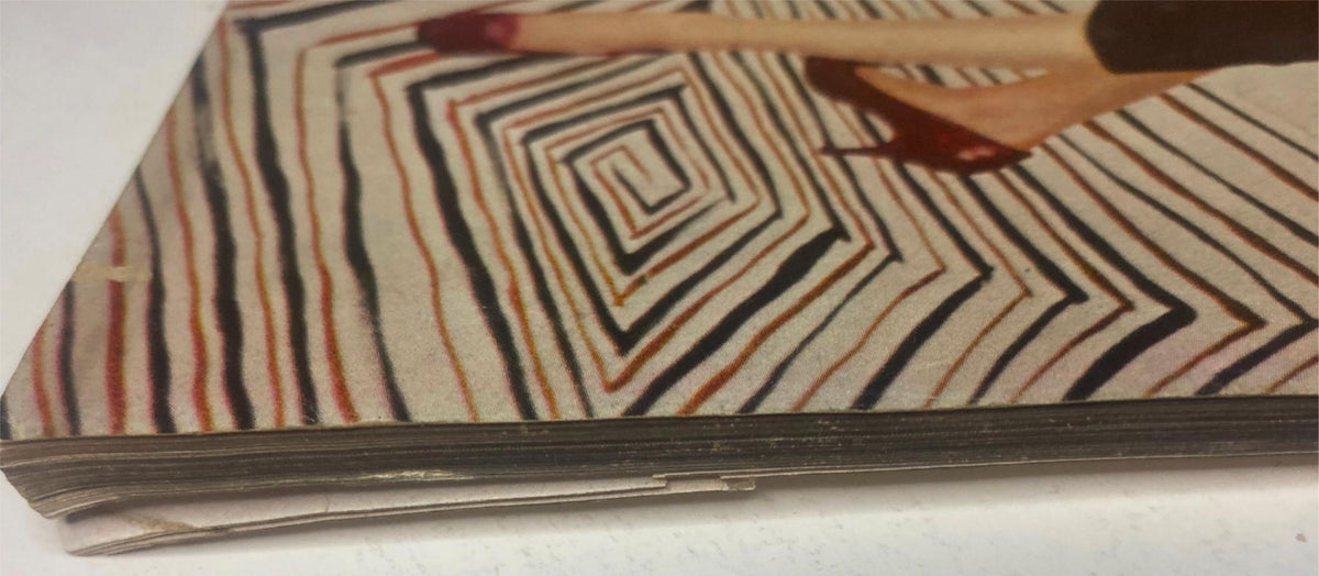 Detailed view of page edges with wear from Vogue Magazine August 15, 1955, emphasizing the authentic vintage condition and aesthetic of mid-century publications.