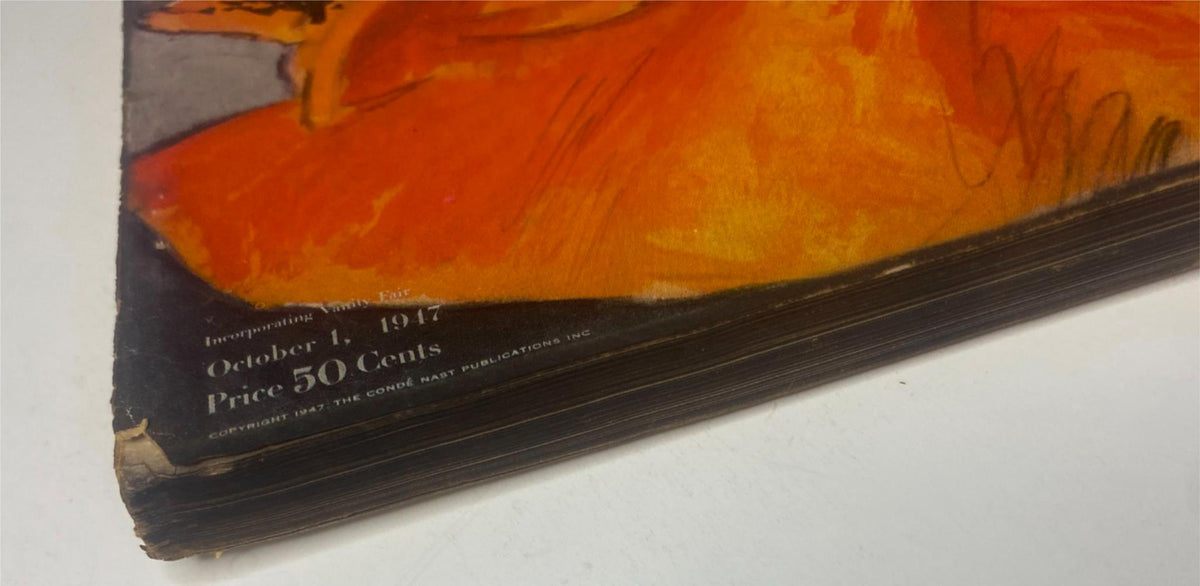 Side view of Vogue Magazine October 1, 1947 showcasing the issue's publication date and price, indicating its vintage condition with clear signs of wear.