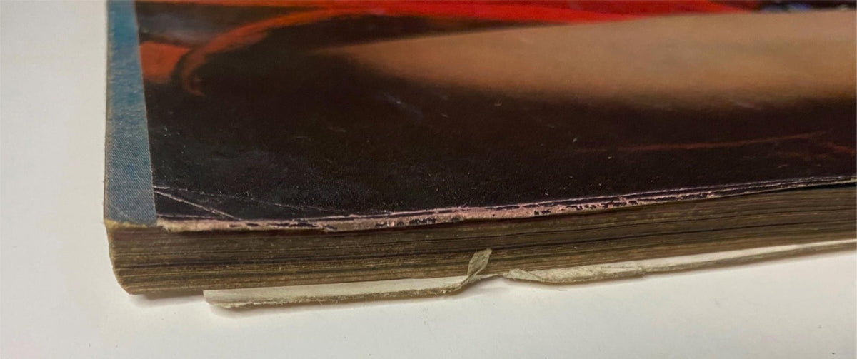 Close-up of the spine of Vogue Magazine from November 15, 1961 featuring Sondra Peterson on the cover, showcasing vintage characteristics such as binding wear and age, emphasizing its historical significance in fashion publishing.